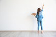 © Africa Studio - Little girl painting on white wall indoors