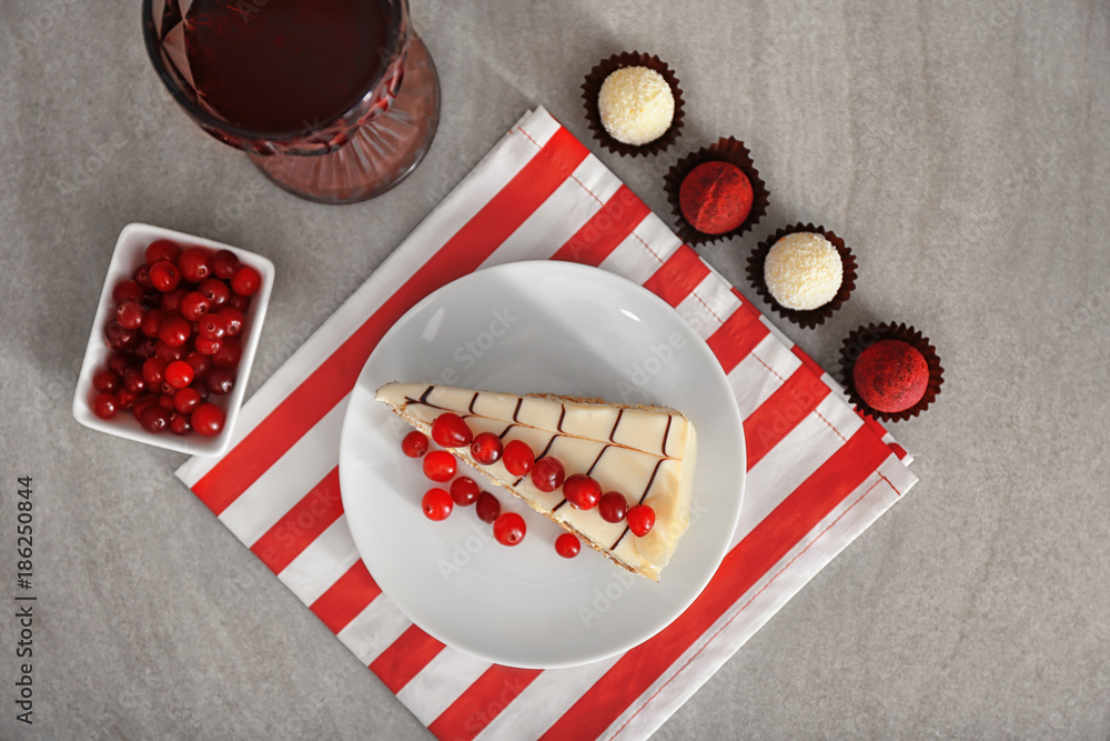 Composition with piece of tasty Esterhazy cake and candies on table