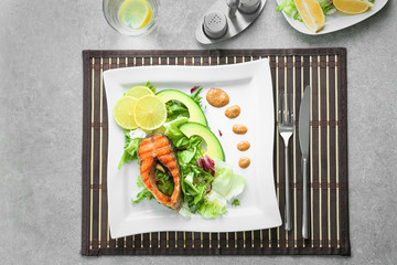 Poster - Delicious fried rainbow trout with salad and sauce on plate, top view