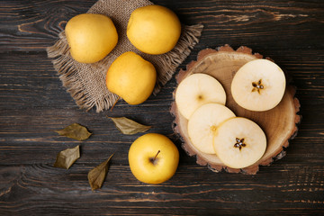 Wall Mural - Ripe yellow apples on wooden table, top view