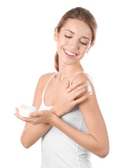 Canvas Print - Young woman applying body cream on white background