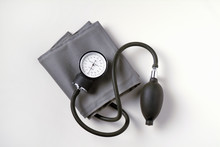 Blood Pressure Cuff On White Background.  Also Known As A Sphygmomanometer It Is Used To Measure The Blood Pressure Of Patients In A Medical Environment.