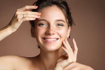 Charming woman with perfect skin on beige background. Beauty & Skin care concept