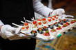 © Angelov - Server holding a tray of appetizers at a banquet