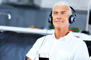 Wall Mural - Handsome gray haired senior man with headphones