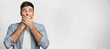 © wayhome.studio  - I will not say anything! Young male model has dark hair covers mouth with hands, dressed casually, isolated over white concrete wall with copy space for your text. Attractive man tries keep silence