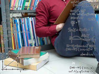 Asian university life concept. Young teenage student reading book in college library.