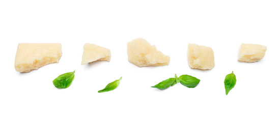 Wall Mural - pieces of Parmesan cheese with basil on white background