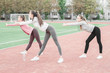 © valerii kalantai - Three girls doing aerobic exercises at the football stadium