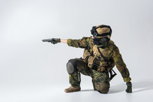Side View Severe Soldier Firing With Pistol While Wearing Balaclava And Helmet. War Concept. Copy Space