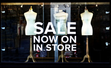 Sale Shop Window Sign At Night Illuminated Lights Clothes Store At Mall Late