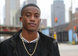 Street scene young African American male model against Dallas Texas skyline.