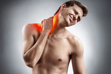 Wall Mural - Man feeling exhausted and suffering from neck pain. Medical concept.