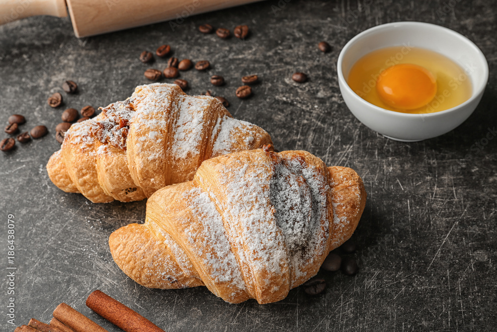 Tasty croissants on grey table