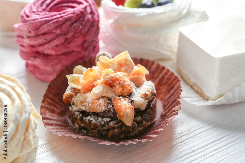 Tasty praline cake on wooden background