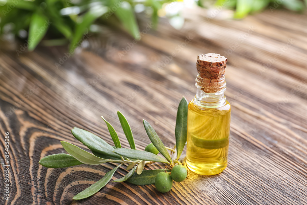 Bottle with olive oil on wooden table