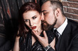 © khosrork - Love and passion concept, closeup.Woman looking side. Bearded man kissing redhead sensual woman.