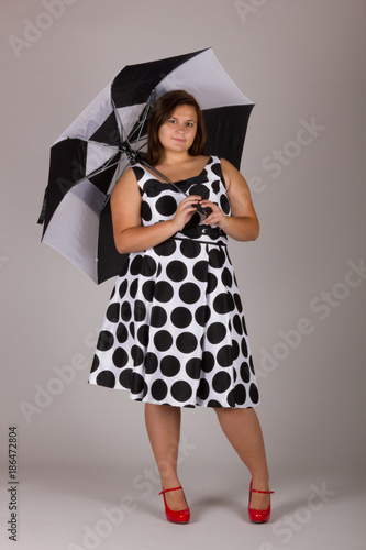 black and white polka dot dress with red shoes