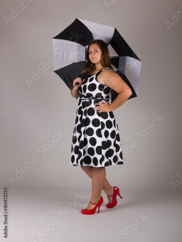black and white polka dot dress with red shoes