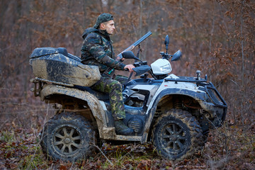 Hunter on ATV in the forest