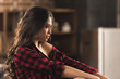 © LIGHTFIELD STUDIOS - side view of beautiful pensive girl in checkered shirt looking away at home