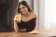© LIGHTFIELD STUDIOS - sexy girl in checkered shirt eating croissant and drinking orange juice for breakfast