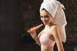 © LIGHTFIELD STUDIOS - sexy girl in bra and towel eating carrot and looking at camera