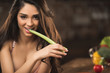 © LIGHTFIELD STUDIOS - sexy young woman in underwear eating celery and smiling at camera