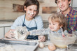 © LIGHTFIELD STUDIOS - adorable little kid helping his parents with cooking at kitchen