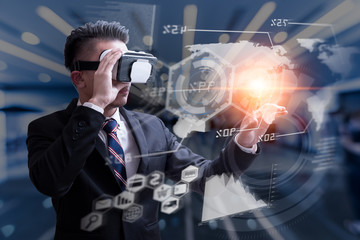 The abstract image of business man using a vr glasses overlay with virsual hologram image and blurred architecture is backdrop. the concept of communication, internet of things and future life.