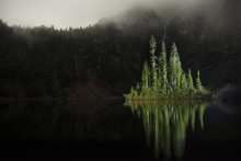 Scenic View Of Trees Reflecting In Lake At North Cascades National Park