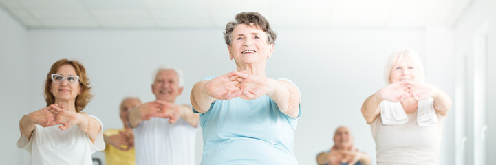 Poster - Smiling elderly woman stretching