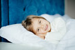 © F8  \ Suport Ukraine - health and beauty concept - little girl sleeping at home with smile in her bed