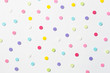Confetti. Colorful dots view from above on a light background. Top view
