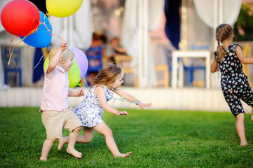 Little boy and girl having fun during celebrating birthday party