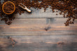 Fresh roasted coffee beans in bowl and scoop on dark wooden table top view copyspace. Coffee background.