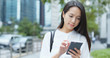 © leungchopan - Woman use of smart phone in city