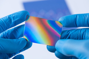 Piece of new type of material or thin coating with improved properties in laboratory in scientist hands
