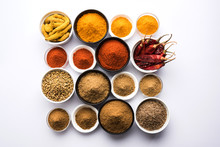 Indian Colourful Spices. Group Photo Of Four Basic Indian Spices Like Raw Red Chilli, Turmeric, Coriander And Cumin Powder. Selective Focus

