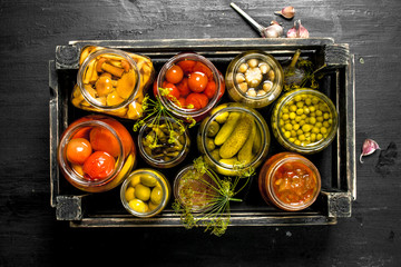 Wall Mural - Preserves vegetables in glass jars in an old box.