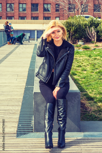 Eastern European Woman wearing black leather jacket, long leather boots ...