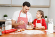 © jpleskachevskaia - Curious female pretty child helps her father who mixes eggs, sit at kitchen, have pleasant conversation, enjoy togetherness. Little kids and her male parent bakes something delicious for party.