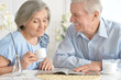 © aletia2011 - Senior couple drinking tea  and reading magazine