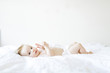 © Jessica Peterson/Tetra Images - Portrait of baby girl (6-11 Months) lying down on bed
