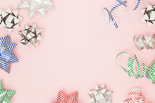 Festive Copy Space With Wrapping Pull Bows On Pink Background. Holiday And Sales Flat Lay Concept, Top View.