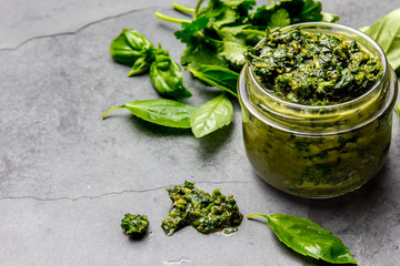 Chimichurri sauce. Argentine green parsley basil sauce chimichurri for barbecue asado in glass jar, gray slate background