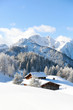 Amazing winter scenery. Alpine hut covered with a snow 