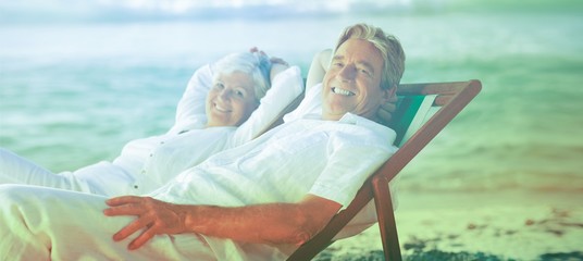 Elderly couple relaxing in their deck chairs