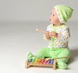 © Dmitry Lobanov - Portrait of Infant child baby boy kid toddler sitting in light green body and play with xylophone toy