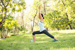 © ronnarong - Beautiful woman doing yoga exercises in the park. Concept of healthy lifestyle.